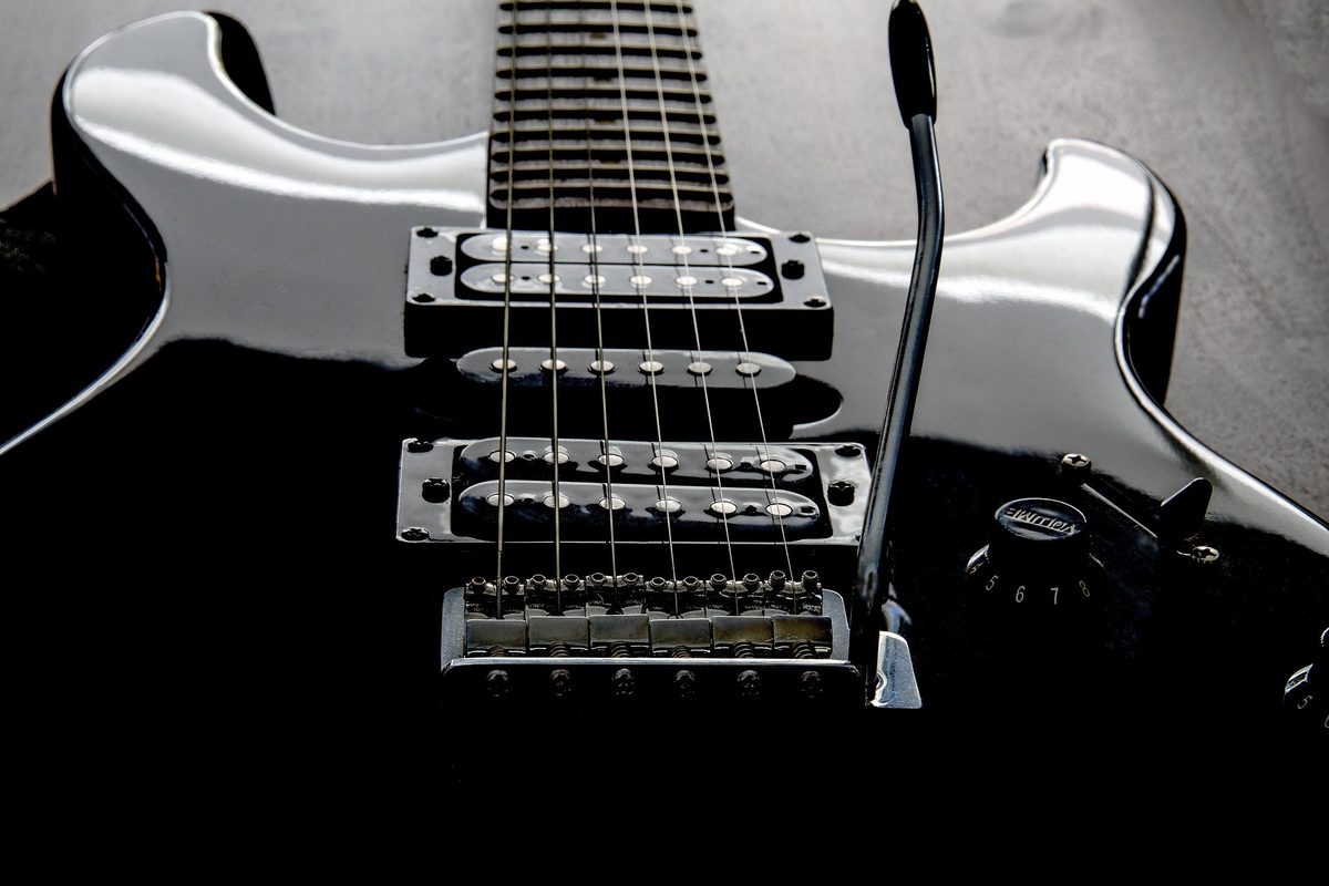 Nahaufnahme einer E-Gitarre mit Tonabnehmern und Reglern